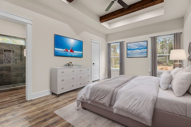 bedroom featuring light wood-type flooring, beamed ceiling, baseboards, and ceiling fan