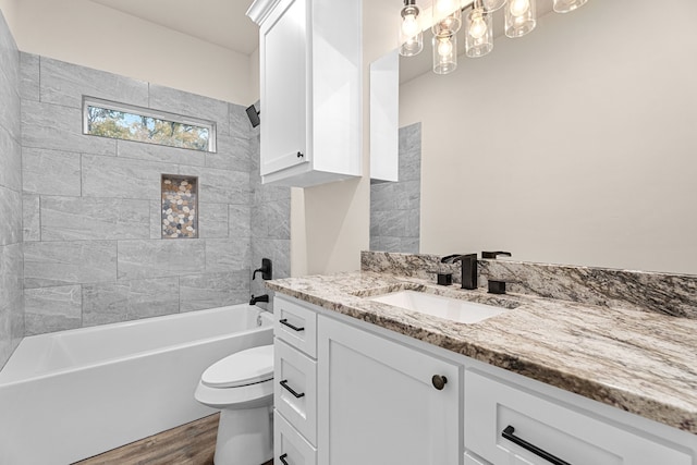 full bathroom featuring shower / bathtub combination, vanity, toilet, and wood finished floors