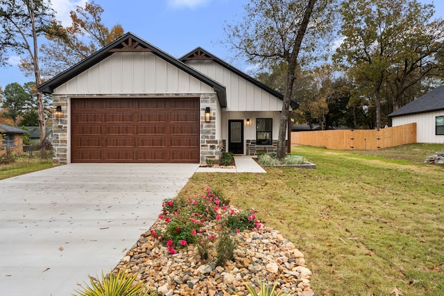 modern farmhouse style home featuring a garage, stone siding, concrete driveway, and fence