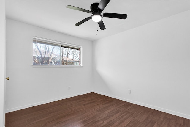 unfurnished room with dark wood-type flooring, baseboards, and a ceiling fan