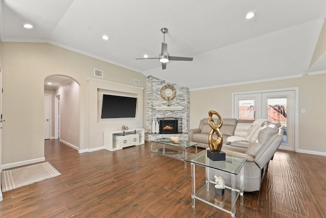 living area featuring arched walkways, visible vents, dark wood-style flooring, vaulted ceiling, and crown molding