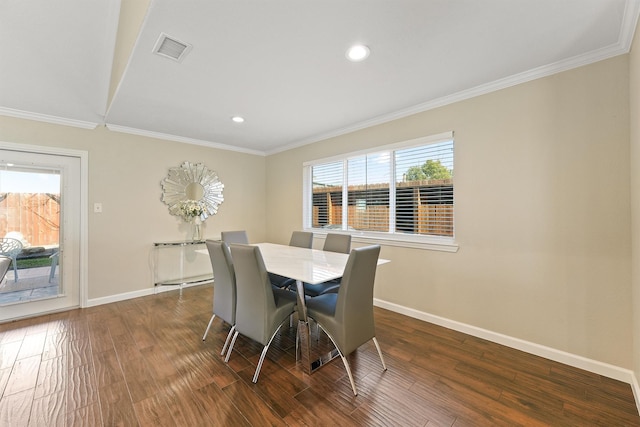 dining area featuring ornamental molding, dark wood-style flooring, visible vents, and baseboards