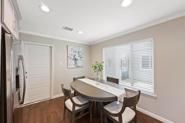 dining room featuring ornamental molding, dark wood-style flooring, and baseboards