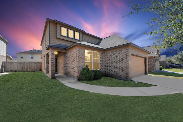 traditional-style home with a garage, brick siding, fence, driveway, and a lawn