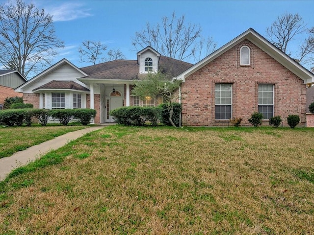 view of front of house featuring a front yard and brick siding