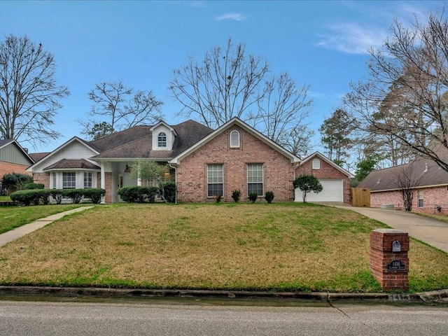 view of front of property featuring a garage, a front yard, brick siding, and driveway