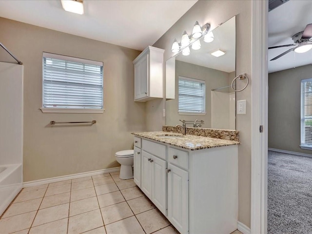 full bathroom with baseboards, toilet, ceiling fan, tile patterned flooring, and vanity