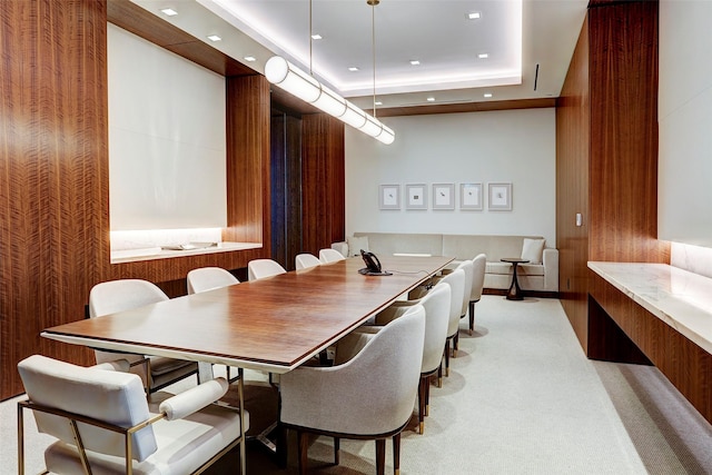 dining room with recessed lighting, a raised ceiling, and carpet