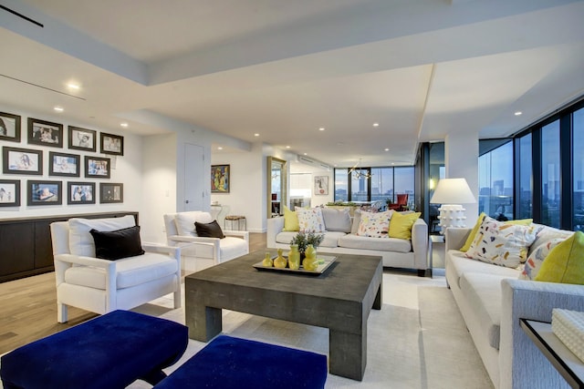 living area with recessed lighting, a healthy amount of sunlight, and light wood-style floors