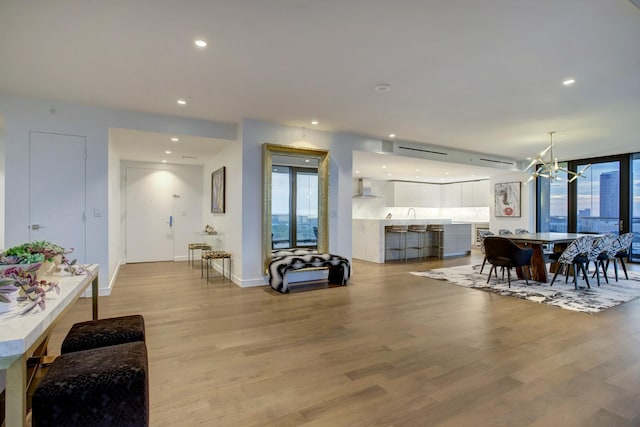 dining area with an inviting chandelier, recessed lighting, baseboards, and light wood finished floors