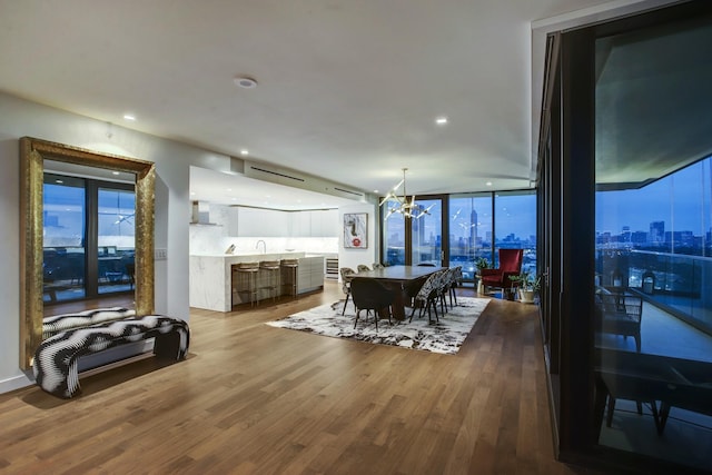 dining area featuring recessed lighting, expansive windows, dark wood-type flooring, and a chandelier