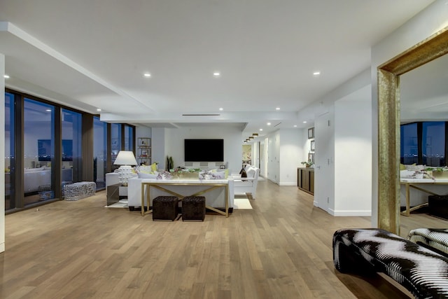 living area featuring recessed lighting, light wood-type flooring, and baseboards