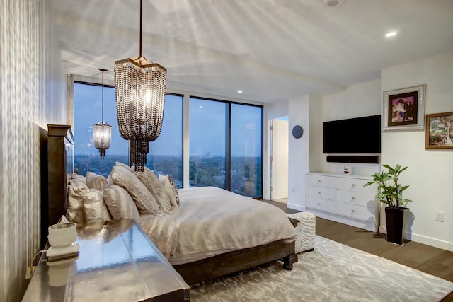 bedroom with recessed lighting, baseboards, an inviting chandelier, and wood finished floors