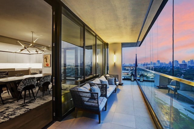 balcony at dusk with a view of city and outdoor lounge area