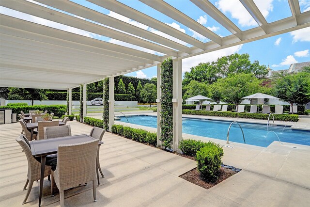 community pool featuring a patio area, outdoor dining area, a pergola, and fence