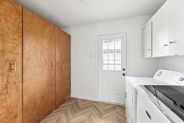 laundry area with cabinet space, baseboards, and independent washer and dryer