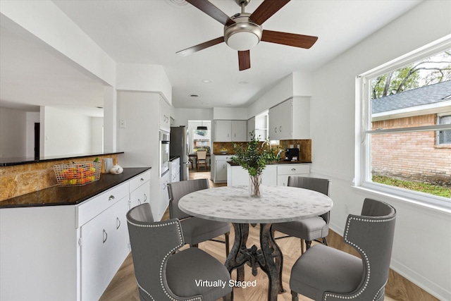 dining room featuring wood finished floors and baseboards