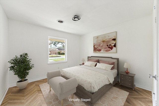 bedroom with visible vents and baseboards