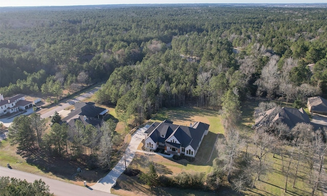 birds eye view of property featuring a view of trees