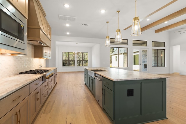 kitchen with light wood-style floors, appliances with stainless steel finishes, visible vents, and decorative backsplash