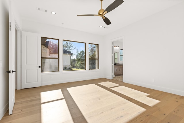 unfurnished bedroom with light wood-type flooring, baseboards, and recessed lighting