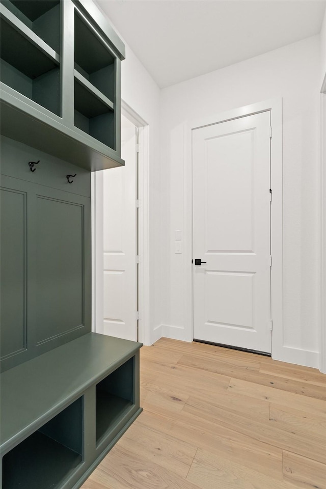 mudroom with baseboards and light wood finished floors