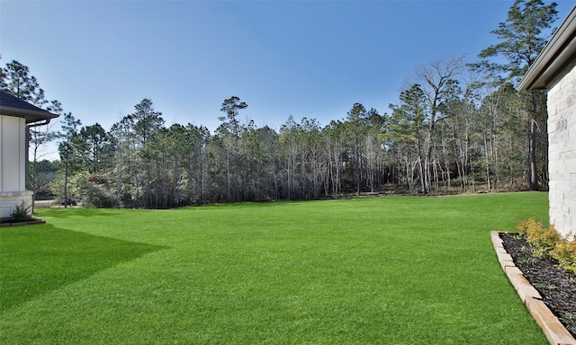 view of yard with a forest view