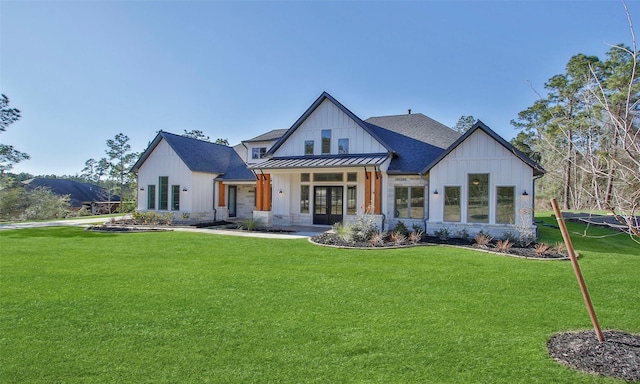 view of front of property with metal roof, a shingled roof, french doors, board and batten siding, and a standing seam roof