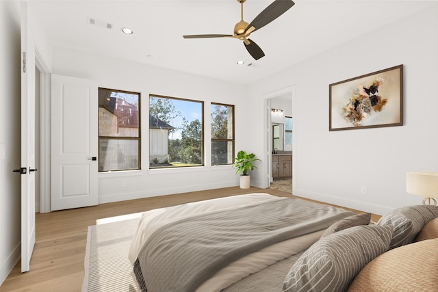 bedroom with baseboards, light wood finished floors, and recessed lighting