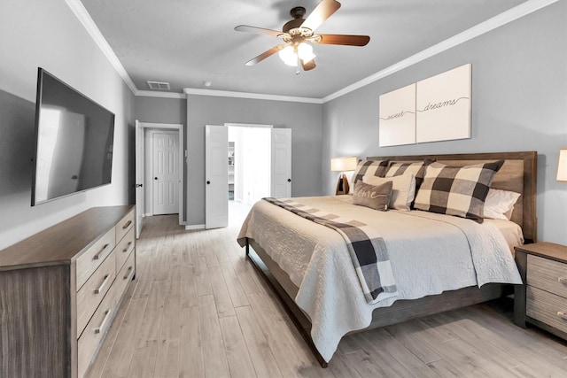 bedroom with light wood finished floors, visible vents, baseboards, ceiling fan, and crown molding