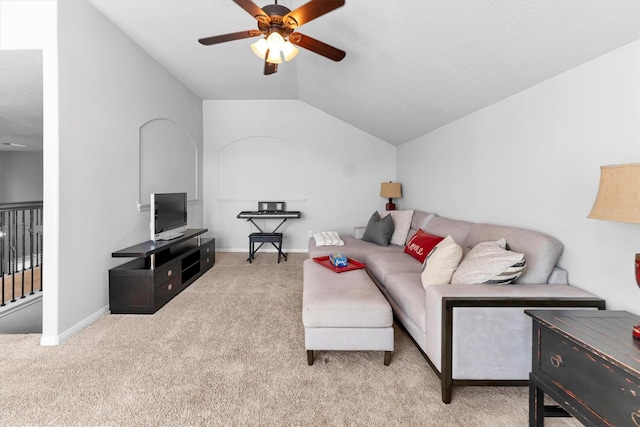 living room featuring light carpet, ceiling fan, baseboards, and vaulted ceiling