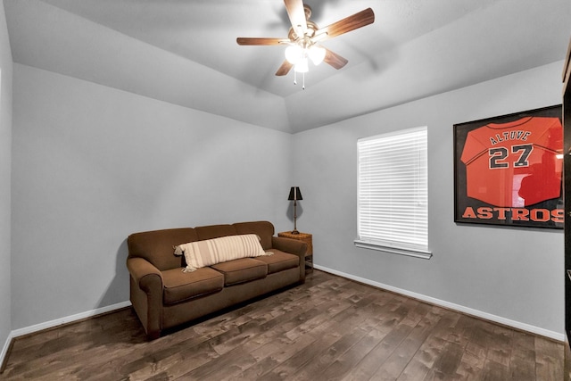 living area featuring lofted ceiling, ceiling fan, baseboards, and dark wood finished floors