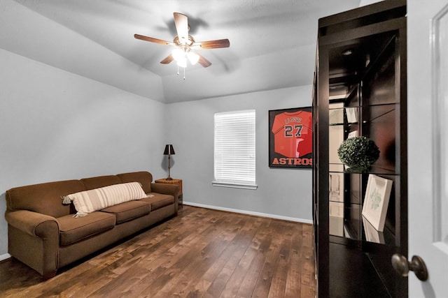 living room with lofted ceiling, dark wood-style floors, ceiling fan, and baseboards