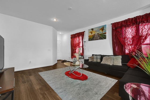 living area with recessed lighting, dark wood finished floors, and baseboards