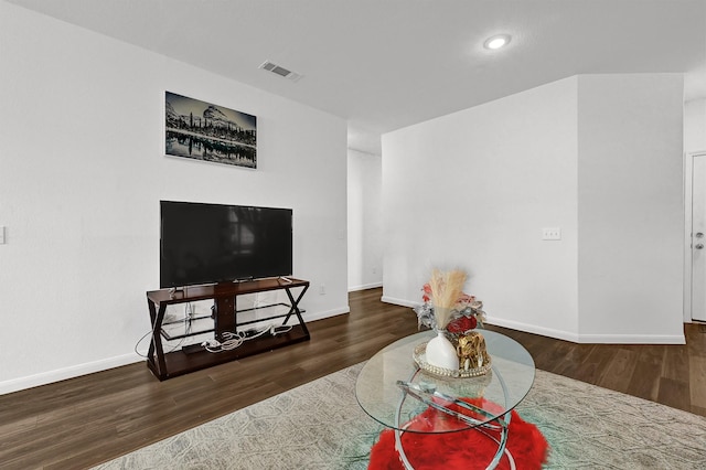 living room with visible vents, dark wood finished floors, and baseboards