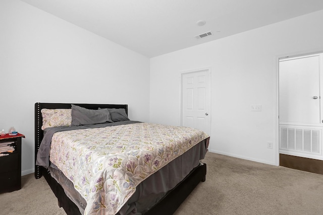 bedroom featuring light carpet, baseboards, and visible vents