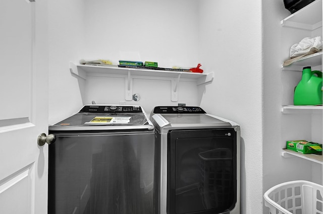 clothes washing area featuring laundry area and washer and dryer