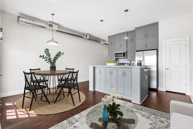 1011 Studemont St Unit 304, Houston, TX 77007 - kitchen featuring stainless steel appliances, gray cabinets, baseboards, and dark wood-style floors
