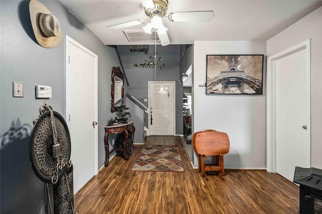 foyer entrance with a ceiling fan, visible vents, dark wood finished floors, and stairway