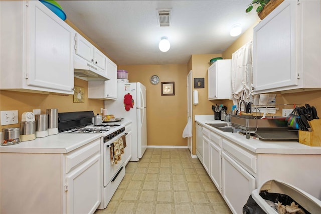 kitchen featuring white appliances, white cabinetry, and light countertops