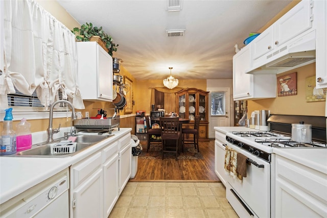 kitchen featuring under cabinet range hood, white appliances, a sink, white cabinetry, and light countertops