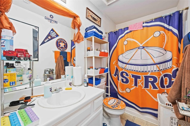 bathroom featuring curtained shower, vanity, and toilet