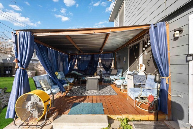 view of patio with a wooden deck and fence