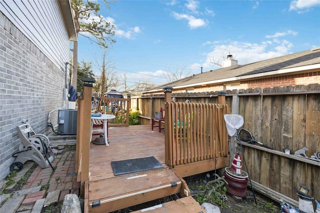 wooden terrace featuring fence and cooling unit