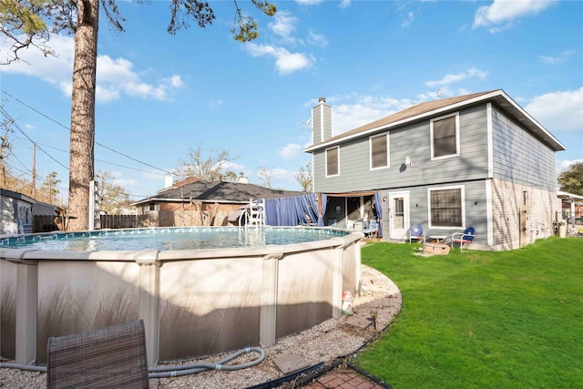 view of swimming pool with a fenced in pool and a yard