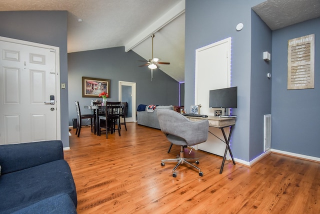 office area with lofted ceiling with beams, baseboards, visible vents, and wood finished floors