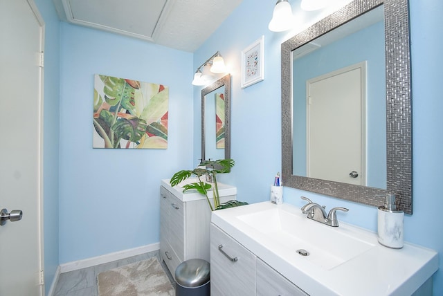 bathroom featuring baseboards and vanity