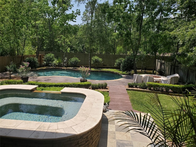 view of pool featuring a fenced backyard, a fenced in pool, and an in ground hot tub