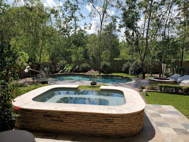 view of swimming pool with a fenced in pool, a patio area, a fenced backyard, and an in ground hot tub