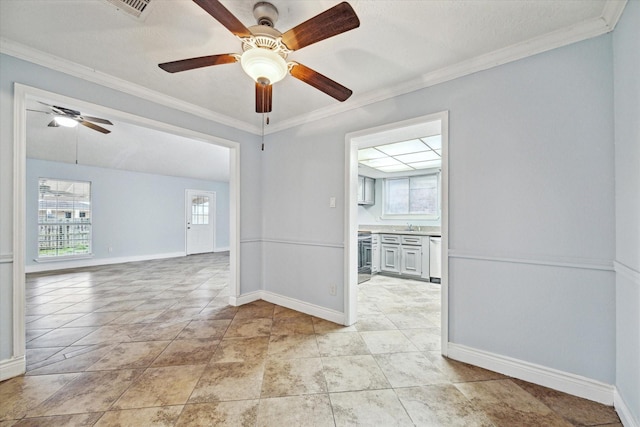 spare room with ornamental molding, visible vents, plenty of natural light, and baseboards